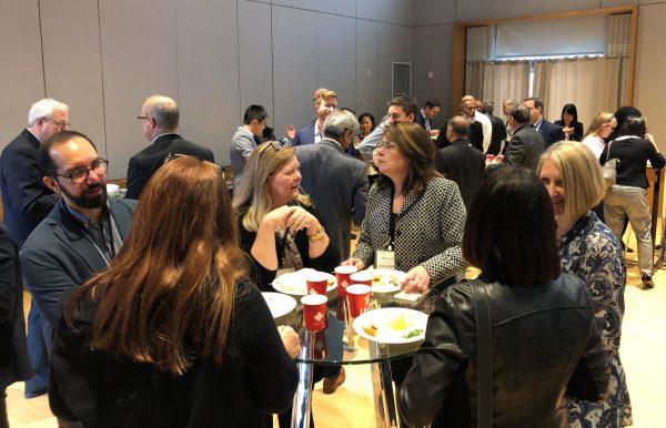 Professionals networking and exchanging ideas during a TechConnex insight session reception