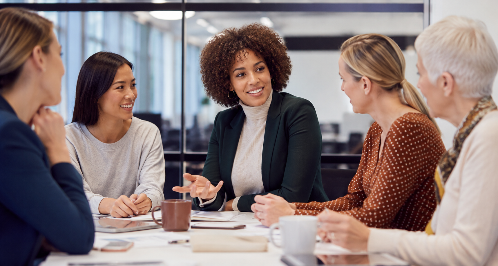 Business Women talking around a table